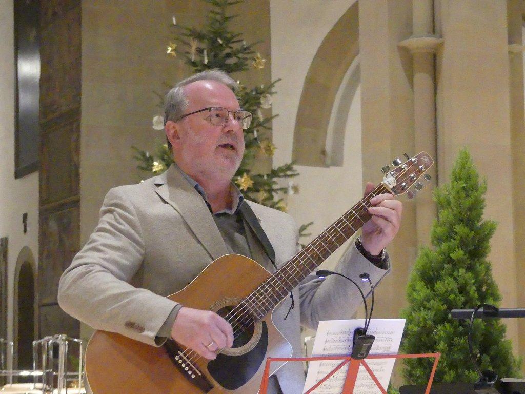 Wolfgang Brändlein singt ein eigenes Lied, begleitet von der Gitarre